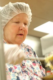 Mary Buchanan dishes a spoonful of noodles on a tray Friday in the Moffat County Jail kitchen. Buchanan, the jail’s food service supervisor, has worked at the jail since June 2006. She said she tries to treat inmates the way she would like to be treated.
