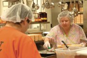 Mary Buchanan prepares lunch Friday at the Moffat County Jail with inmate Sean Egbert. Buchanan works with three inmates throughout the week to prepare meals at the jail.