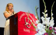 Colorado Northwestern Community College nursing Student of the Year Corine Schweikert addresses her classmates and audience members at the nursing pinning ceremony Friday at the Moffat County High School auditorium. A total of 18 nursing students in the Class of 2011 received pins.