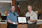 Craig Police Department Officer Ryan Fritz accepts the Craig Police Department’s Life Saving Medal from Police Chief Walt Vanatta at Tuesday’s Craig City Council meeting. Fritz helped three Moffat County Sheriff’s Office deputies save the life of an inmate who had a heart attack. Fritz said any other officer in the situation would have done the same thing.