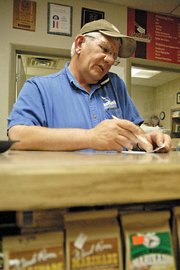 Dave Satterwhite, co-owner of Brother’s Custom Processing, Inc., takes an order Friday in his store. Satterwhite recently attended the American Cured Meat Championships in Reno, Nev. Brother’s won reserve grand champion for whole muscle jerky.
