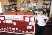 Katie Grobe, director of Yampa Valley Pregnancy Center, stands Saturday in the organization’s office. The group loans baby gear such as cribs, high chairs, strollers and more to new parents, and also provides counseling and classes.