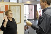 Moffat County Coroner Kirk McKey, right, swears in deputy coroner Beka Warren in January. Warren, whose family placed great importance on education, earned a doctorate in psychology so she could help families deal with grief and loss.
