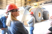 State Senator Jean White, R-Hayden, views heavy equipment Wednesday during a tour of Trapper Mine, Inc. The tour was part of a busy agenda for White, two representatives of the Colorado Department of Labor and Employment, and community leaders. The group also toured Tri-State Generation & Transmission and participated in an education session to discuss the economic impacts of regional energy industries and the workforce. In the background is the largest front loader in the world – a $3 million dollar behemoth made by LeTourneau.