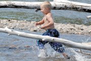 Colt Call, 4, runs Friday through a shallow area of the Yampa River off Pebble Beach. The section is one of the slower parts of the river, though as of Friday, the U.S. Geological Survey recorded the discharge level at 3,290 cubic feet per second near Craig. The average for the area is 589 cubic feet per second.