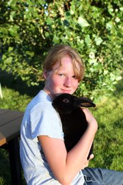 Emma Balstad, 12, poses with her rabbit, Quill, on July 20 at her home in Maybell. In her fourth year of 4-H, Emma balances four animal projects with cake decorating. She said 4-H teaches her important life skills and keeps her busy during the summer months.