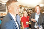 Gov. John Hickenlooper discusses the job market Friday with a Hayden resident at Yampa Valley Feeds. The governor was in Northwest Colorado to discuss his economic development strategy for the state.