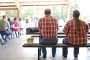 Craig residents Pat and Betty Ann Duzik listen Sunday as singer Loretta Earle performs a country gospel song during Cowboy Church at the Moffat County Fairgrounds. The annual event is in its fourth year.