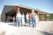 A crowd enters the covered picnic area Sunday at the Moffat County Fairgrounds for the fourth annual Cowboy Church. Meeker resident Fred Ellis, a cowboy poet and minister, led the sermon.