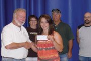 Andy Bullen, chairman of the Yampa Valley Friends of the NRA, presents a $2,000 scholarship check to Miranda Blomquist. Blomquist is a 2011 Moffat County High School graduate and has competed nationally in 4-H shooting sports. She will attend the University of Wyoming this fall.