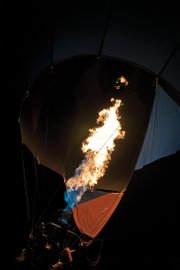 Flames spew from burners to inflate a hot air balloon Saturday night at Loudy-Simpson Park. Propane is the fuel of choice for the balloons.