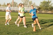 Four Moffat County High School cross-country runners practice at MCHS. The boys and girls teams both won the 4A regional meet last season, and with 14 returning runners this season, head coach Todd Trapp said both teams have a good chance to repeat.