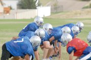 The Moffat County High School varsity football teams lines up in goal-line offense Aug. 24 on the MCHS practice field. The Bulldogs are returning seven starters on both sides of the ball as the team hopes to upend Glenwood Springs and Palisade at the top of the Western Slope League.