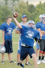 Bubba Ivers, a Moffat County High School junior, drops back to pass during practice. Ivers started at quarterback last season as a sophomore, and he hopes to lead his team to the playoffs in his second year at the helm.