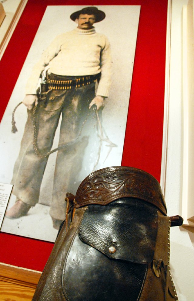 A pair of chaps made by “Bad Bob” Meldrum sits on display at the Museum of Northwest Colorado. In the background is a photograph taken of him while he was working as a guard for Telluride mine workers in the early 1900s. Meldrum’s career included stints as a Pinkerton agent, marshal, union strikebreaker and range detective. His life and exploits are featured in a new book about Colorado’s history of outlaws.
