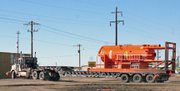 A truck pulls out onto First Street in Craig on Friday trailing a mud tank from Rig 111 bound for Casper, Wyo. Rig 111 had been atop Harper Hill in Hamilton conducting stick pipe drilling operations on behalf of Shell Oil Company.