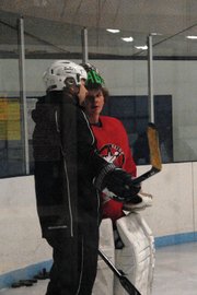 Rick Villa, left, talks to goalie Trent Parrott during practice Nov. 10 at the Moffat County Ice Arena. Rick took over for Mark Samuelson this season and said the team’s hustle will decide a lot of games.