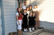 John Bolton and his wife, Teri, weren’t initially sure if they wanted a large family. But, after their first child, Sarah, was born, it became easier to consider having more children. Pictured here, back row, from left, are Sarah, 20; John and Teri; and Marie, 12. In the front row, from left, are Karen, 18; Rachel, 8; and Laura, 11. The twins, Bekah and Carmen, 5, are pictured in front, wearing matching black dresses.