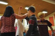 Sambu Shrestha, right, a Sunset Elementary School fifth-grader, dances in a square dance during a program Friday at the school. Sunset Elementary has put on the dance program for more than 20 years, physical education teacher Susan Nicholson said.