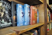 Copies of “Catching Fire” and “Mockingjay,” the second and third installments, respectively, of Suzanne Collins’ popular trilogy, sit on a shelf Thursday at Downtown Books. Novels in the futuristic series were a hot item at the bookstore this Christmas, and they are among the shop’s most popular books, employees said.