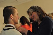 bridget manley/daily press
Melinda Hall, right, helps Derek Maiolo, a Moffat County High School sophomore, prepare for the second act of “Rehearsal for Murder” Thursday night in the dressing room behind the MCHS auditorium. Hall, a friend of MCHS theater teacher Heather Dahlberg, volunteered to help with the production.