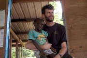 John Wall poses for a photo with Jellas, a young African girl, during a stint at a Sudanese orphanage in 2005. Wall posted this photo on his eHarmony profile, where it caught the attention of Tracey, his future wife, who had done medical work in Mali and Kenya. “Our mutual love of Africa was definitely a draw to each other,” said Tracey, 32.