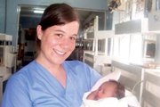 Tracey Wall holds an infant at Tenwek Hospital in Kenya, a rural medical facility where she completed part of her physican’s assistant training in 2005. Tracey had wanted to do medical work in Africa since she was a young girl, she said.