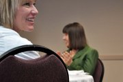 Amy Knights, foreground, former Moffat County United Way board member, smiles while Donna Stover, United Way treasurer, claps during an awards luncheon Wednesday at Holiday Inn of Craig. They were among roughly 45 people who attended the event.