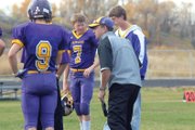 Mike Bates, the Little Snake River Valley (Wyo.) School six-man football head coach, runs through pre-game drills during the 2011 football season. Bates is also a social studies teacher at LSRV.
