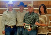 John Raftopoulos poses with his children, from left, Angelo, George and Mari Katherine, on March 31 during Raftopoulos Ranches’ fourth annual Angus bull sale in Loma. Raftopoulos was recognized by the Colorado Angus Association as the 2011 Promoter of the Year.