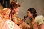 The evil queen (Julia Roberts), left, stares down her kind and beautiful stepdaughter, Snow White (Lily Collins), in “Mirror Mirror.” The movie is a twist on the fairy tale favorite about the princess who meets seven dwarves while in exile from her kingdom.