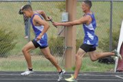 Moffat County High School seniors Miguel (right) and Rene Molina exchange the baton in the boys 800 meter relay at the Clint Wells Invitational hosted by Moffat County High School. The relay team placed third in the event with a time of 1:34.66