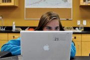 Brittany Swindler, 13, works on a River Watch report Tuesday morning at Craig Middle School. The students average all data collected this year and last year before comparing them, she said.