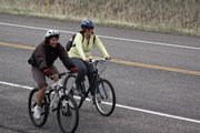 A pair of cyclists in the 26th annual “Where the Hell’s Maybell?” bike ride travel west Saturday along U.S. Highway 40. Cold weather put a damper on the number of participants in the event.