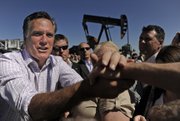 Former Massachusetts Gov. Mitt Romney shakes hands with supporters following a May 9 campaign stop near the field office of K.P. Kauffman Co., a privately owned oil and gas company in Fort Lupton. Romney is scheduled to return to Colorado on Tuesday, and appear for a public event at 9 a.m. at Alice Pleasant Park in Craig.