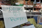 A sign welcoming Republican presidential candidate Mitt Romney sits Friday inside Pam Design Interiors at 512 Yampa Ave.