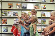 Madison Doolin, 3, right, claps along as Christy Gonzales, not pictured, Moffat County Libraries programs coordinator, reads a children’s book about the Fourth of July during story-time at the Craig branch. Weekly story-times and the libraries’ other summer reading activities coincide with an initiative spearheaded by Lt. Gov. Joe Garcia and the Colorado State Library to encourage children and adults to read more during the summer.