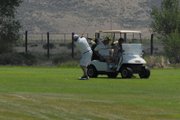 A golfer takes a swing while his playing partners look on from the sixth hole fairway Sunday at the Cottonwood Classic. The Classic is an annual 54-hole tournament played on the last weekend in June, which brought in 127 golfers from around Colorado in 2012.