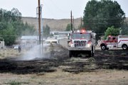 A Craig Fire/Rescue firefighter douses a power pole Sunday night on a vacant lot near the intersection of 14th Street and Yampa Avenue. The small blaze was extinguished shortly after it was reported at about 6:30 p.m., and no homes were damaged.