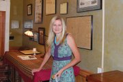 Kimberly Ritchie examines the many pictures and clippings within The Meeker Hotel. The hotel has played host to many historical figures in its 100-plus years, ranging from President Theodore Roosevelt to outlaw Billy the Kid.