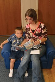 Jessie Gorley reads to her son, Tristin Bush, 3, during the Moffat County School District’s extended-year program at the district’s Early Childhood Center. They are sitting on a child-sized couch and reading a book purchased through Connections 4 Kids’ classroom grant opportunity for licensed providers who participated in Connections 4 Kids’ Early Childhood Environment Rating Scale training. Connections 4 Kids also offers educational scholarships for early childhood educators.