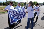 Jo Ann Baxter, right, holding the banner, is a Craig resident and candidate for Colorado House District 57. She is shown here campaigning with her husband, Brian, on Saturday during the Silt Heyday in Garfield County. Baxter has been campaigning for the office in recent weeks in Moffat, Rio Blanco and Garfield counties.
