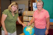 Sunset Elementary School teachers Melany Neton, left, and Cheryl Arnett point to the Czech Republic on a globe in Arnett’s classroom. In November, the two will attend the Microsoft Partners in Learning 2012 Global Forum in Prague, an honor they earned after attending the U.S. event from July 31 to Aug. 1 in Redmond, Wash.