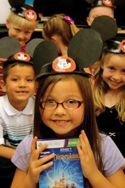 A group of Sunset Elementary School teacher Cheryl Arnett’s first-graders don their Mickey Mouse ears and display the Xbox 360 Kinect game “Disneyland Adventures.” Earlier in the year, Arnett and fellow teacher Melany Neton used the game as a project to teach students how to achieve their goals through the use of educational standards like math, literacy and geography, as well as research and critical decision-making.