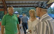 Chuck Grobe, left, a Republican candidate for the Moffat County Commission’s District 2 seat, talks issues with Diane Gallegos, center, and local voter Bill Chase, during a Bears Ears Tea Party Patriots barbecue Thursday night in Craig.