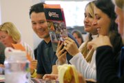 Students at Colorado Northwestern Community College’s Craig campus look Saturday at new marketing materials during new student orientation.
