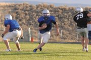 Moffat County High School senior quarterback Bubba Ivers looks to cut up field during a scrimmage against Coal Ridge High School at the Bulldog Proving Grounds Friday. Ivers and the Bulldogs’ new offensive sets looked sharp, as they scored on their first three possessions.