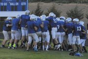 The Moffat County High School football team gets fired up before its scrimmage against Coal Ridge High School Friday night. MCHS dominated at the Bulldog Proving Grounds, shutting out the Titans’ varsity offense.