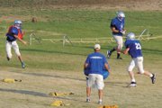 Matt Hamilton, a Moffat County High School sophomore, throws a pass on the run at a practice this summer. Hamilton, the team’s backup quarterback, will likely see snaps as part of the new offense, and will get some time at safety.