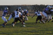 Michael Samuelson (middle), a Moffat County High School senior running back, tries to hit the hole on a run during the first quarter of the MCHS football game against Rifle High School at the Bulldog Proving Grounds. After rushing for over 100 yards last week, Samuelson was mostly held in check by the Rifle defense.